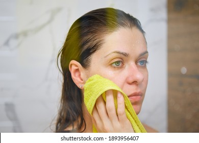 Young Woman In Shower Stall Drying Face Off With A Yellow Towel After Bathing.