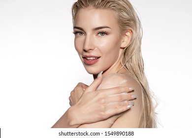 Young Woman Showering Side View. Pretty Girl With Long Blond Hair Applying Gel Shower Foam On Naked Shoulders. Cleaning And Scrubbing Body. Headshot Portrait On Light Blank Copy Space