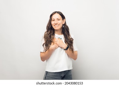 Young Woman Is Showing Compassion. Gesturing With Hands Over Chest.