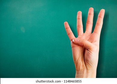 Young Woman Showing Four Fingers With Hand