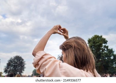 Young Woman Showing Heard Shape At The Music Festival  