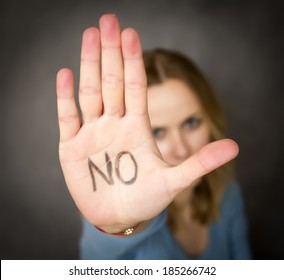 young woman showing her denial with NO on her hand