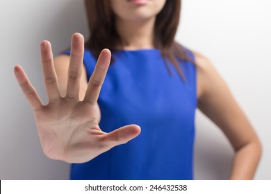 Young Woman Showing Her Denial With NO On Her Hand