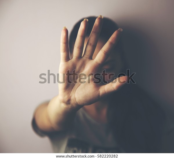 young woman\
showing her denial with NO on her\
hand