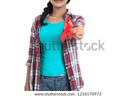 Young woman showing red ribbon HIV, AIDS awareness ribbon, healthcare and medicine concept