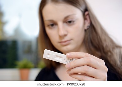 Young Woman Showing Self Test Card For Corona Or Covid-19