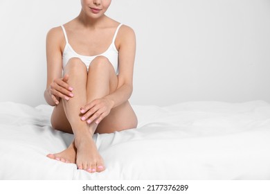 Young woman showing smooth skin after epilation on bed, closeup, space for text - Shutterstock ID 2177376289