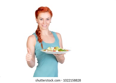 young woman showing thumbs up and salad