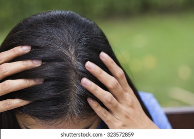 Young Woman Shows Her Gray Hair Roots