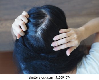 Young Woman Shows Her Gray Hair Roots
