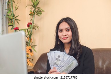 A Young Woman Shows Her Huge Performance Bonus In Cash, Seen In 100 Dollar Bills. Proud Of Making A Lot Of Money.