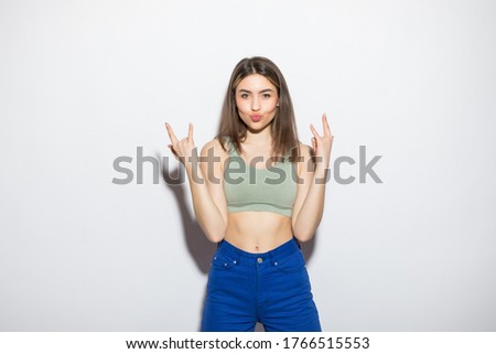 Young woman shows a sign of rock on white background