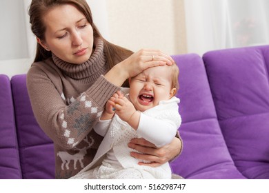 A Young Woman With A Sick Crying Baby