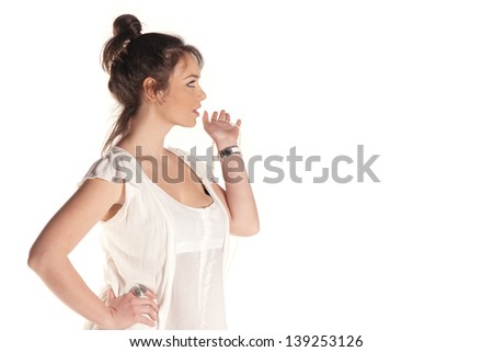Young woman sideshot looking at something isolated on white