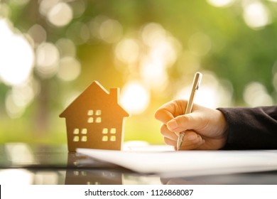 Young Woman Sign Banking Loan Contract For Buying A New Land House From Real Estate Agent, Instalment Payment By Monthly Basis As Planning For Long Term Contract. Dreaming To Become Owner Residence.