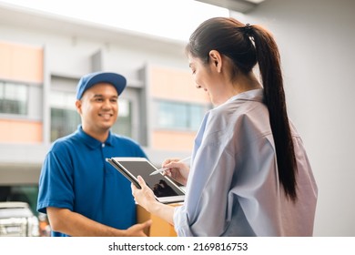 Young woman signing electronic Signature on tablet for agreement of contract digital receiving parcel from blue delivery man from shopping online. Courier man delivering package to destination. - Shutterstock ID 2169816753