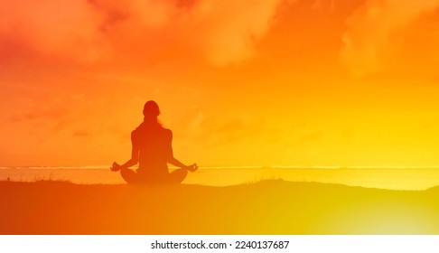 young woman silhouette prating meditation outdoors 