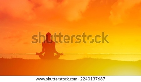 young woman silhouette prating meditation outdoors 