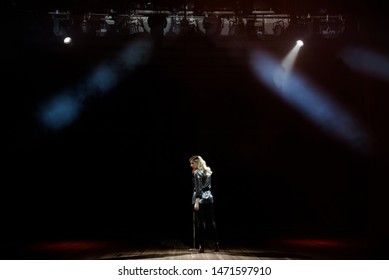 A Young Woman Singer On Stage During A Concert View From The Back