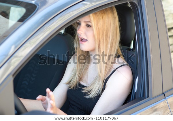 Young woman singing in\
car