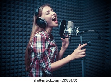 Young Woman Singing In A Recording Studio