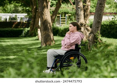 A young woman sits in a wheelchair, thoughtfully gazing at a lush green park. - Powered by Shutterstock