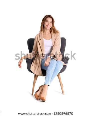 Young woman sitting in armchair on white background