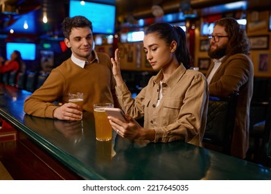 Young woman sitting at bar counter rejecting man - Shutterstock ID 2217645035