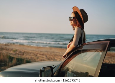 young woman sitting in a beautiful model car