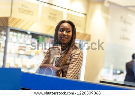 young woman sitting in a coffee shop alone