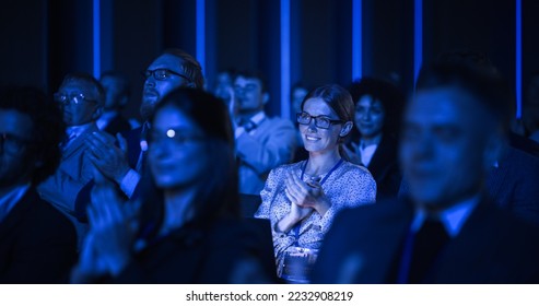 Young Woman Sitting in a Crowded Audience at a Business Conference. Female Attendee Cheering and Clapping After a Motivational Keynote Speech. Auditorium with Young Successful Businesspeople. - Shutterstock ID 2232908219