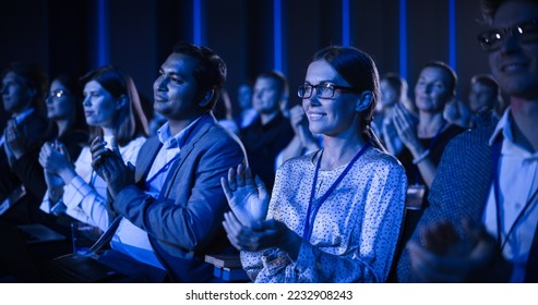Young Woman Sitting in a Crowded Audience at a Business Conference. Female Attendee Cheering and Clapping After a Motivational Keynote Speech. Auditorium with Young Successful Businesspeople. - Shutterstock ID 2232908243