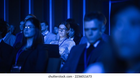 Young Woman Sitting in a Crowded Audience at a Business Conference. Female Delegate Using Laptop to Take Notes. Manager Watching Inspirational Entrepreneurship Presentation About Developing Markets. - Shutterstock ID 2236011673