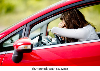 Young woman sitting depressed in car