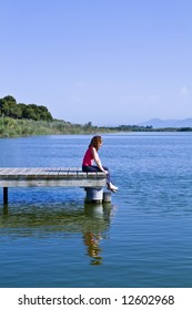 Young woman sitting in the dock of the bay