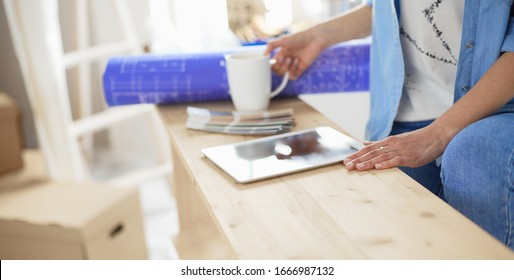 Young woman sitting at home and buying new furniture over the Internet using a tablet computer - Shutterstock ID 1666987132