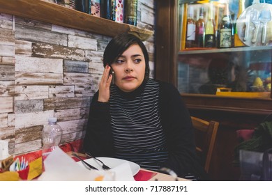 Young Woman Sitting Indoor Talking Smartphone - Conversation, Communication, Voicemail Concept