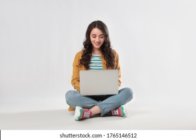 Young Woman Sitting With Laptop On White Background