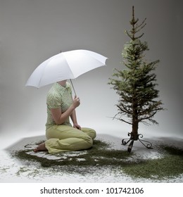 The Young Woman Is Sitting Next To The Poor Christmas Tree