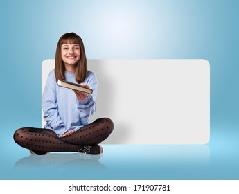 young woman sitting offering a book on a blue room - Shutterstock ID 171907781