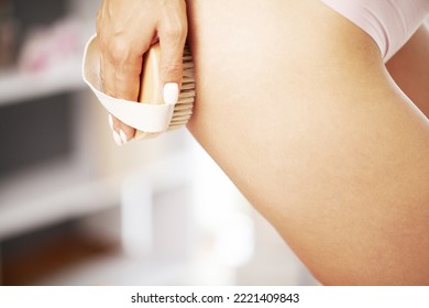 Young Woman Sitting On Bathroom Holding Handle Dry Brush To Side Of Her Thigh