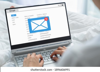 Young Woman Sitting On The Bed And Using Laptop With Checking Email Inbox On Website.