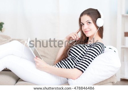 Similar – Happy woman listening to music wearing headphones