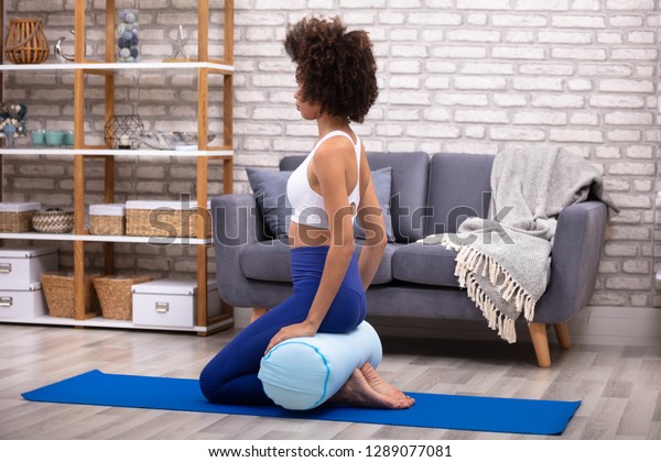 Young Woman Sitting On Exercise Mat Stock Photo Edit Now 1289077081