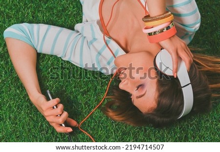 Young woman sitting on green grass . Portreit young woman