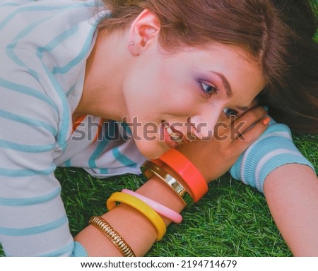 Young woman sitting on green grass . Portreit young woman