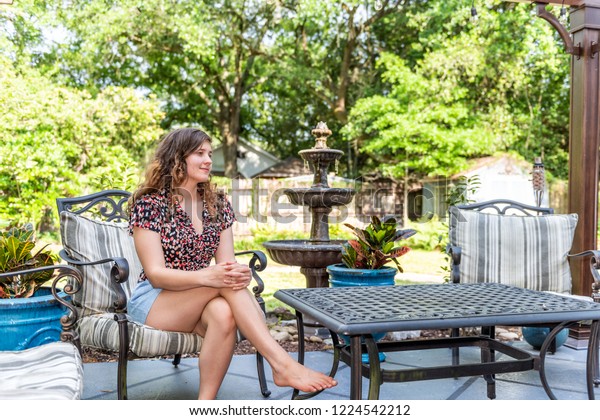 Young Woman Sitting On Patio Chair Stock Photo Edit Now 1224542212