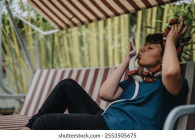 A young woman is sitting on a swing, playfully interacting with colorful pet snakes. The scene captures a moment of connection in a natural, outdoor environment. - Powered by Shutterstock