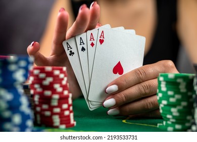 Young Woman Sitting On Table Playing Poker And Holding Cards Proudly Celebrating Victory And Success Very Excited. Poker Game Gambling Woman