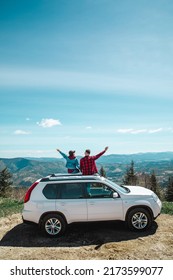 young woman sitting on the top of the suv car at mountain peak enjoying the landscape view at summer sunny day - Shutterstock ID 2173599077